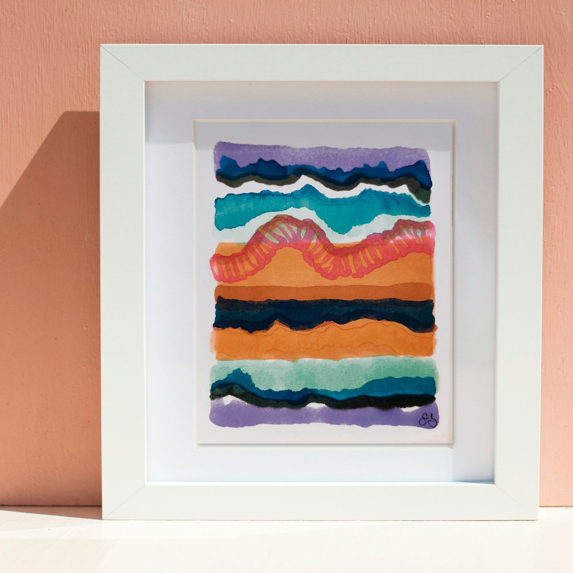Framed abstract watercolor painting with layered bands of orange, teal, and purple